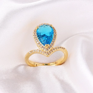 Adjustable gold open ring with large teardrop blue crystal and small zircon pavé accents