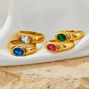Vintage stainless steel gold rings set with colorful oval zirconias on silk background