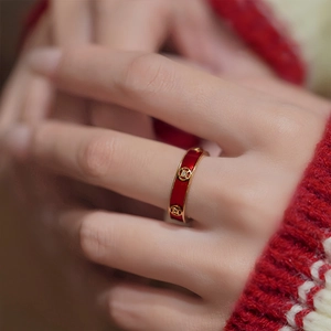 Detail of red enamel gold-plated ring with a traditional Chinese coin hollow pattern