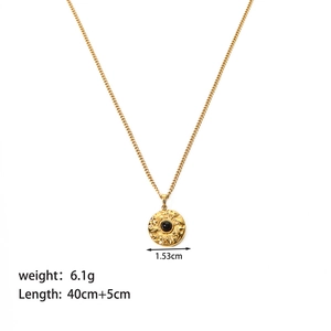 Detail of gold necklace with size specs and black stone pendant diameter 1.53cm