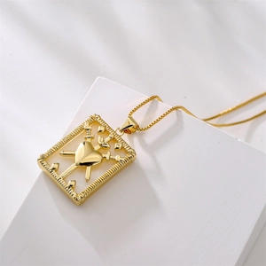 18K gold plated box chain necklace with heart and sword shell pendant on white pedestal