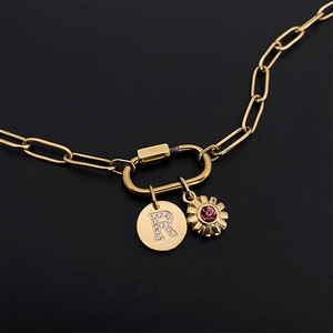 Gold paperclip chain necklace featuring a crystal letter R charm and pink flower pendant