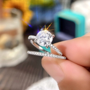 Macro detail of sparkling two-piece wedding ring set with round cut moissanite and micro-pave