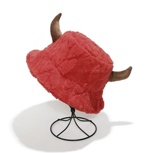 Detail of red plush bucket hat featuring brown horns and soft faux fur texture