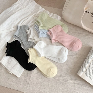 Colorful breathable cotton ankle socks with ribbed texture in a lifestyle setting