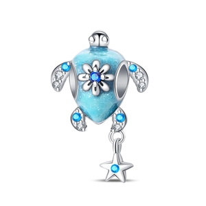 Macro shot of silver turtle charm with blue crystals and hanging starfish detail