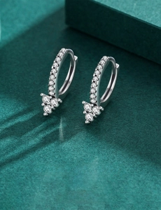 Macro shot of S925 sterling silver hoop earrings with triangular crystal accents