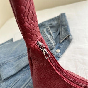 Chic red woven leather handbag with premium silver zipper and refined stitching detail