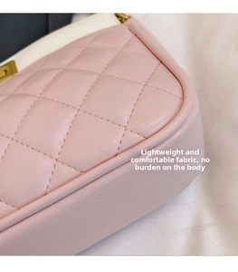 Close-up of pink quilted crossbody bag showing soft faux leather texture and white stitching