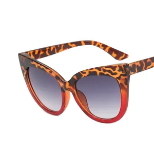 Stylish cat-eye glasses with tortoiseshell to red gradient frames and grey lenses