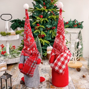 Paire de poupées gnomes de Noël avec bonnets tricotés nordiques dans un décor d'hiver