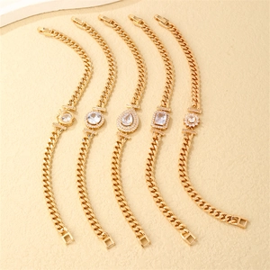 Detail of five gold Cuban link bracelets featuring diverse zircon gemstone centerpieces