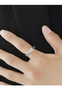 Macro shot of silver textured ring featuring a unique lava wave design on male model
