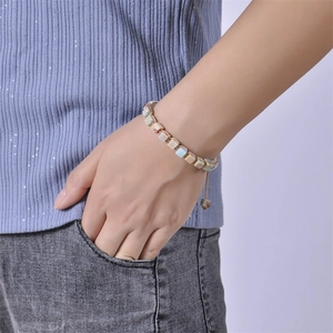 Close-up of bohemian hand-woven bracelet with square natural emperor stone beads on wrist