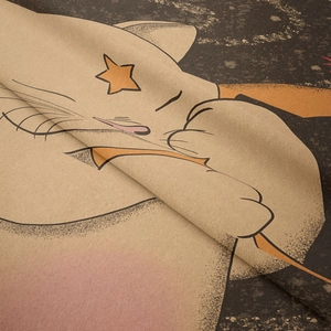 Close-up of soft fabric texture featuring a cartoon cat print on a starry background