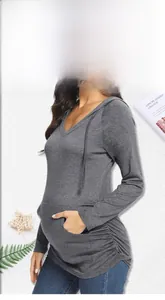 Macro detail of maternity hoodie featuring V-neck, side ruching and front pocket