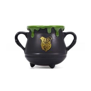 Macro shot of witch cauldron mug featuring Hogwarts crest and green dripping glaze