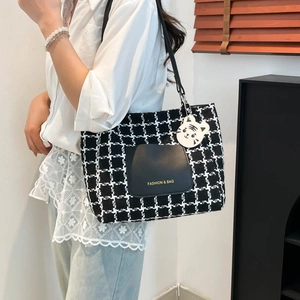 Plaid canvas tote bag with black leather pocket and cute tiger charm for casual wear