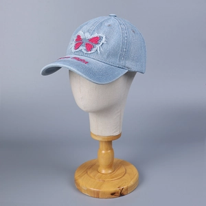Distressed blue denim baseball cap with butterfly patch and flight embroidery on brim