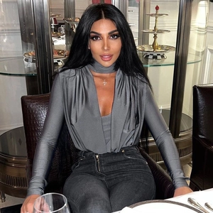 Detail of grey V-neck bodysuit with long sleeves and matching choker on a model