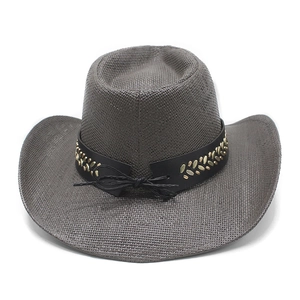 Close-up of deep brown straw cowboy hat featuring gold rivets and black leather band