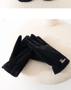 Detail of black thermal gloves with soft suede texture and warm fleece lining
