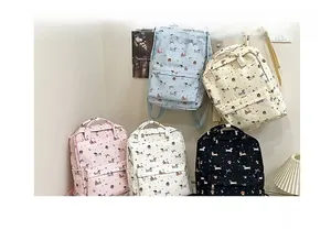 Detailed close-up of multiple printed backpacks featuring cute puppy and bow patterns