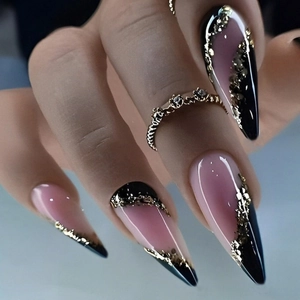 Detail of long pointed nails with pink and black wavy patterns and golden foil accents