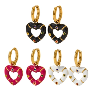 Three pairs of gold plated heart hoop earrings with black, pink, and white enamel details