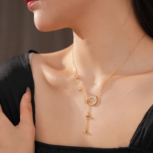Golden Y-shaped necklace with zircon moon and star pendants worn by a model