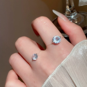 Macro shot of sparkling zircon rings on model finger showing detailed cut and brilliance