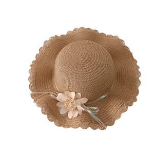 Brown straw hat for girls with wave brim and floral decoration for summer sun protection