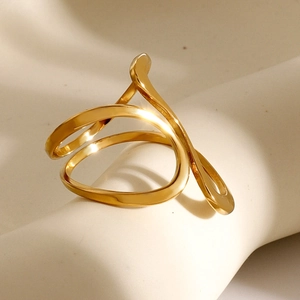 Detail of 18k gold irregular line ring on artistic plaster base with soft shadows