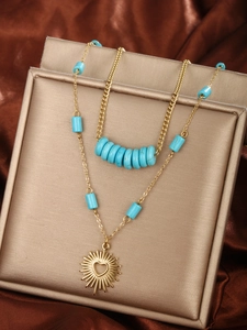 Detail of 14K gold plated double layer necklace with turquoise beads and sun heart pendant
