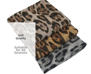 Close-up of three leopard print chiffon scarves in dark brown, gold and grey shades