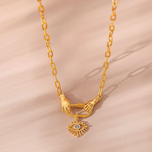 Golden heavy chain necklace with hands clasp and sparkling zircon evil eye pendant