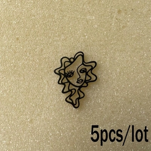 Detailed view of 5pcs lot abstract black metal face pendants for DIY jewelry making