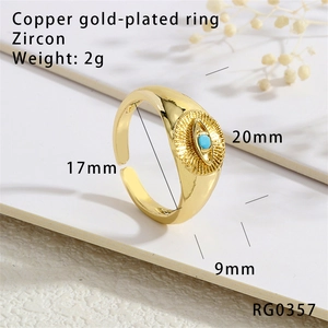 Macro detail of 18K gold plated copper evil eye ring with zircon and turquoise stone