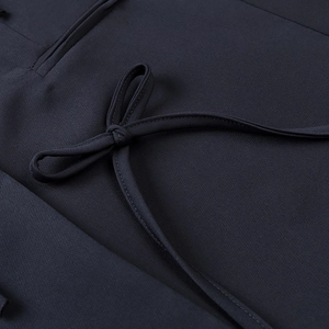 Navy blue blazer with elegant bow tie detail and fine plain weave fabric texture
