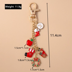 Detailed view of Christmas gold keychain showing charms weight and size measurements