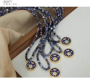 Detail of blue sodalite stone beads and star-moon enamel angel pendant necklace