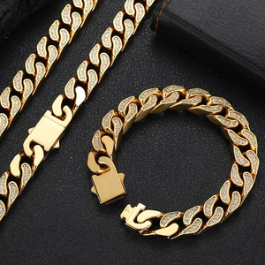 Close-up of 12mm gold-plated stainless steel Cuban link necklace and bracelet set with CZ