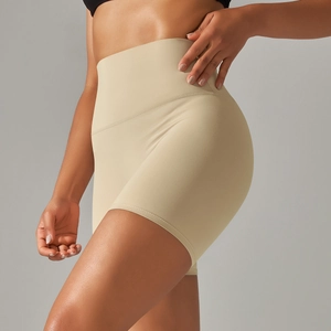 Detail of high-waist yoga shorts showing seamless side stitch and push-up effect