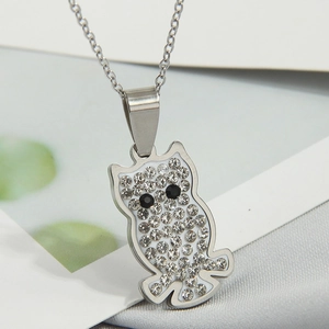 Macro shot of silver owl pendant necklace with sparkling white and black rhinestones