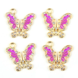 Detailed view of four purple butterfly charms with gold alloy frame and white rhinestones