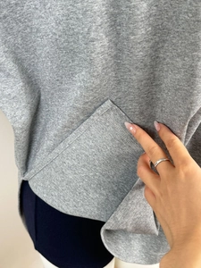 Detailed close-up of premium cotton grey T-shirt stitching and fabric texture
