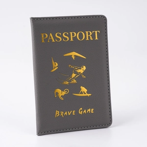 Close-up of dark gray PU leather passport cover with gold foil sport adventure icons