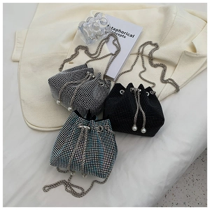 Close-up of rhinestone bucket bags with crystal mesh and pearl drawstring details