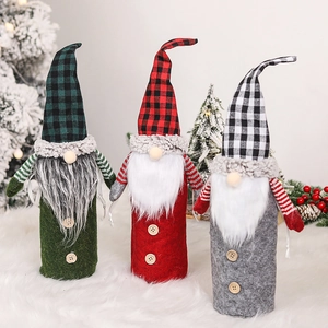 Three Nordic Christmas forest gnome wine bottle covers in red, green and grey plaid design