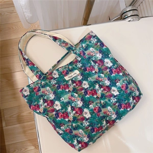 Flat lay of vintage floral cotton lunch bag with zip closure and simple wish label
